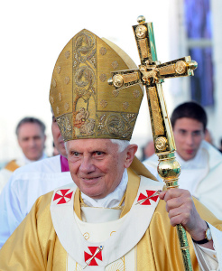 The Pope in a gold robe carrying a staff