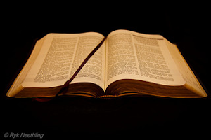 Open Bible on a black background