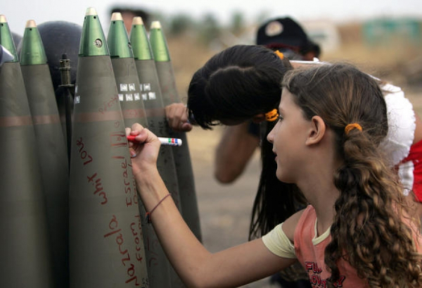 Childen writing graffiti on bombs