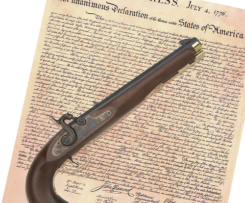 Declaration of Independence with a pistol laying on top