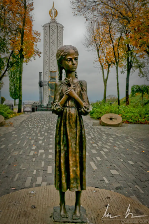 Holodomor statue of an emaciated girl in a dress.