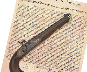 A flintlock piston laying on a copy of the Declaration of Independence