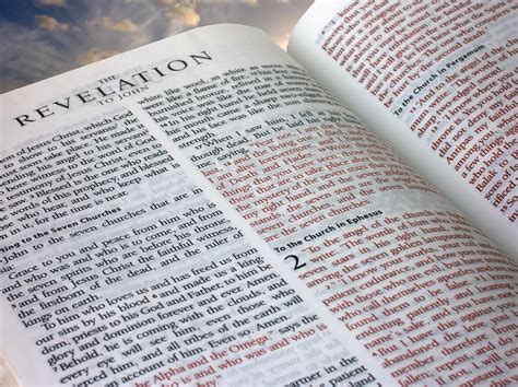 A copy of Scripture opened to the book of Revelation chapter 2.
