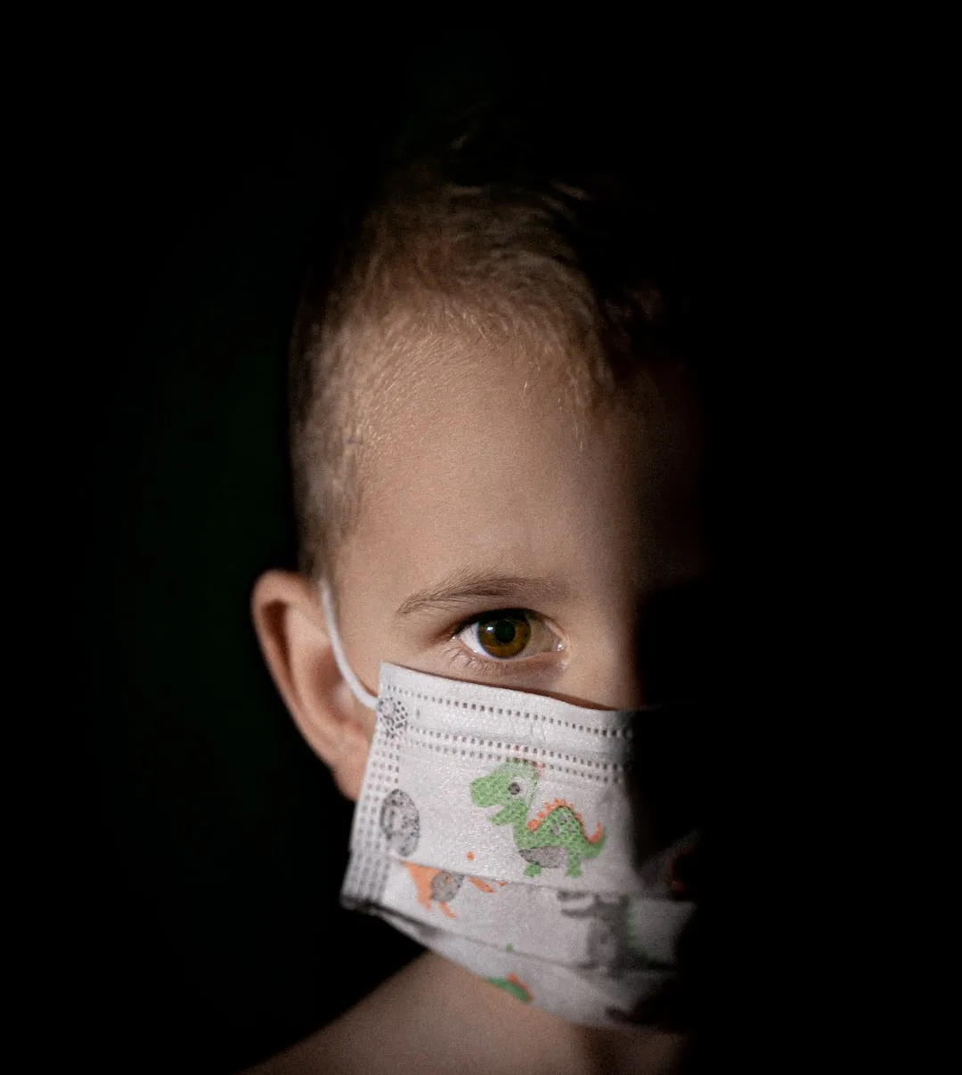 A child in a surgical mask.