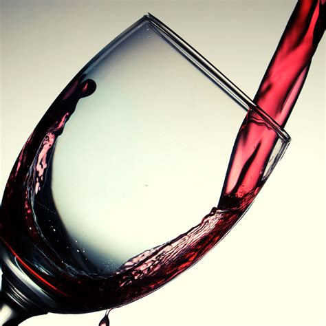 Red wine being poured into a glass.